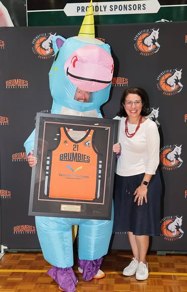 Jamie Howard, Director of Versatile Structures, is pictured wearing a unicorn costume standing alongside Charis Mullen MP, the image reflects Versatile Structures’ commitment to supporting local sporting organisations and fostering community engagement.